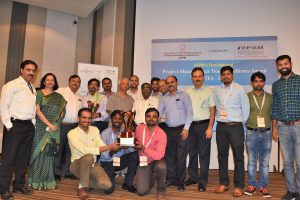 2018 PMTEA Winning Team from NTPC-Kudgi, sitting in front with the National Trophy along with some other participants and TKA Nair, Former Advisor to Prime Minister of India, SK Roy, Director (Projects), NTPC, Adesh Jain, Chairman i2P2M and the Award Director and Ms. Ruchira Jain, MD, CEPM who is on left.